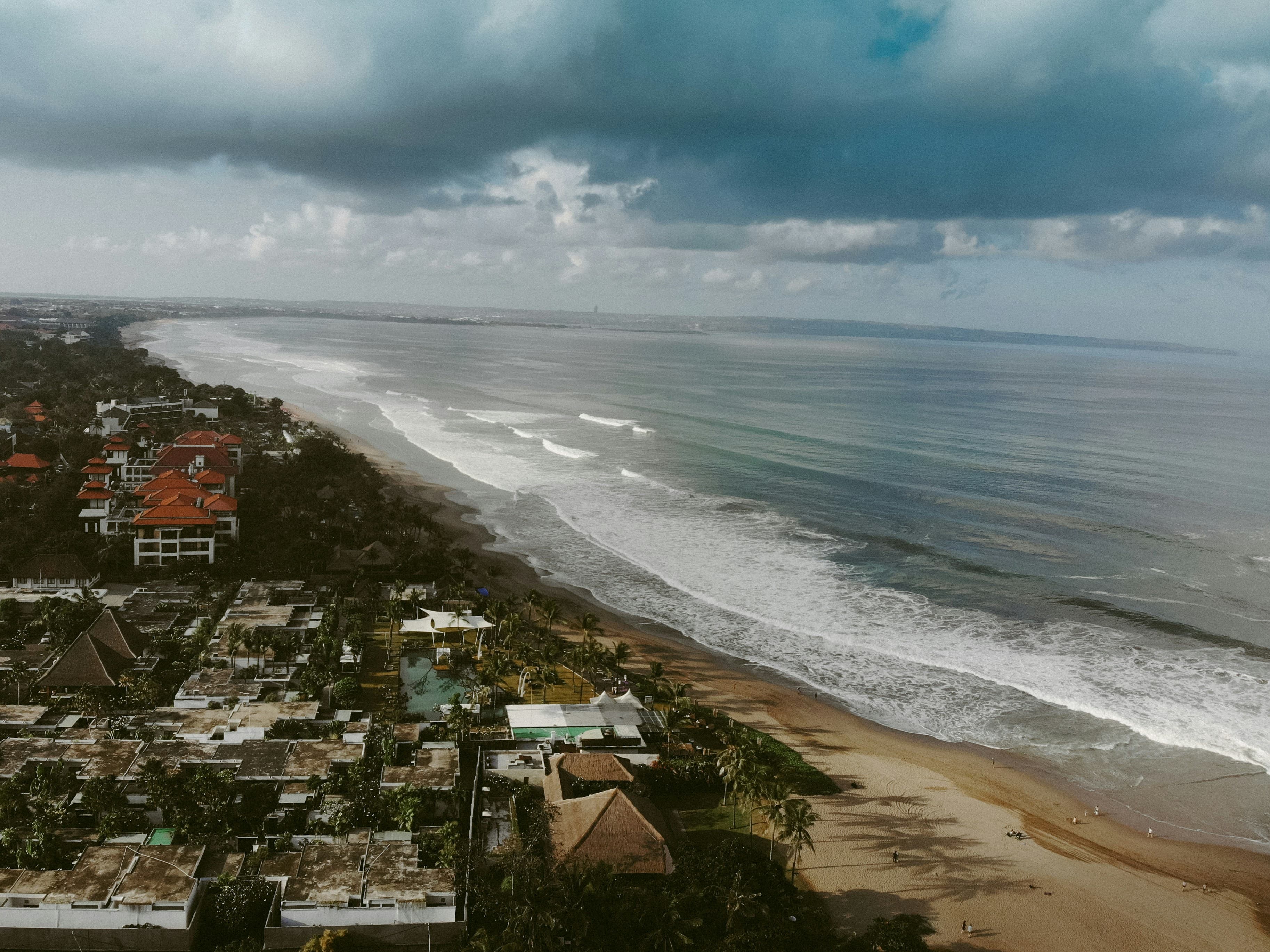 Surfing at Seminyak Beach, Bali, Indonesia